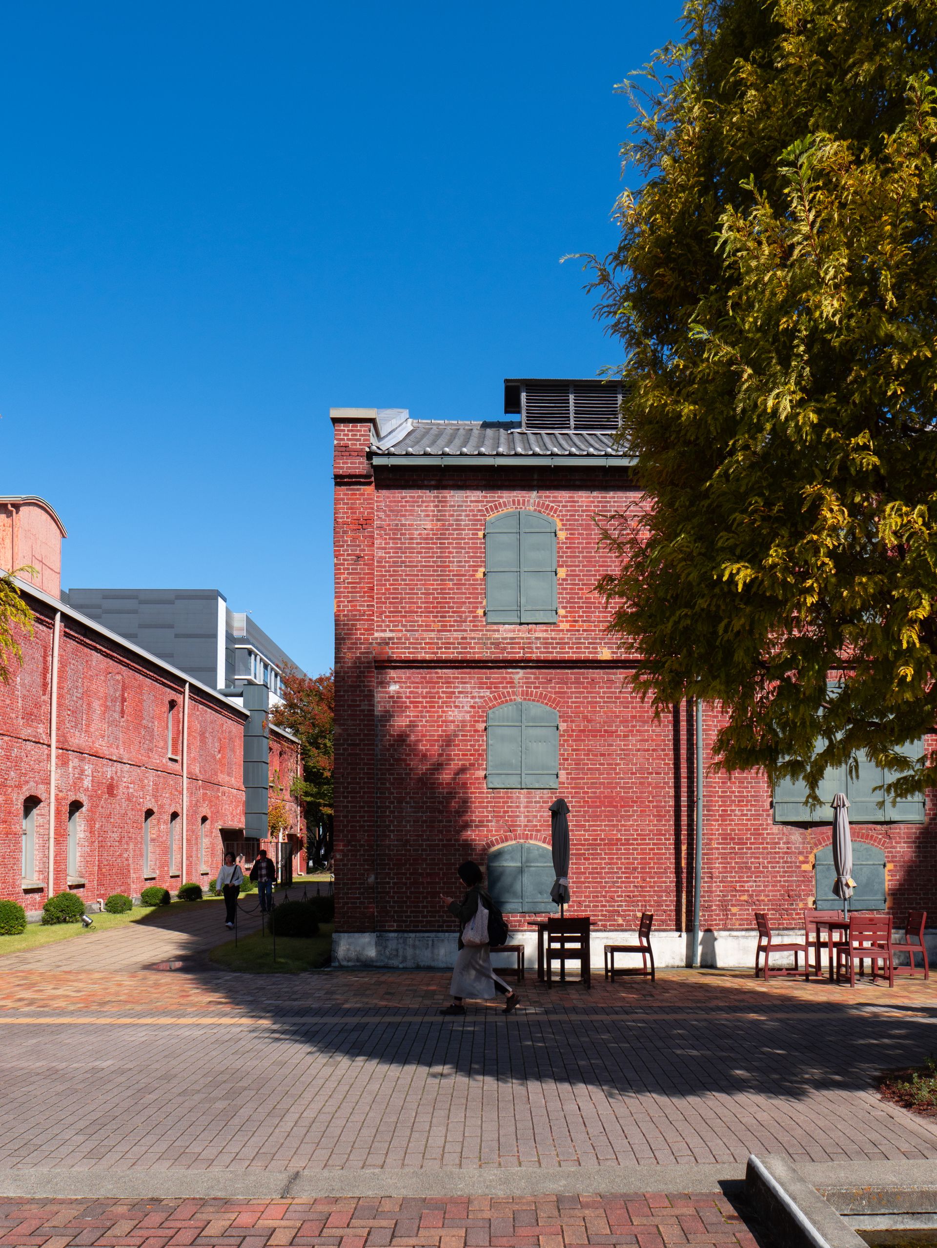 Explore the historic brick architecture of Noritake Garden in Nagoya, Japan, under a clear blue sky.