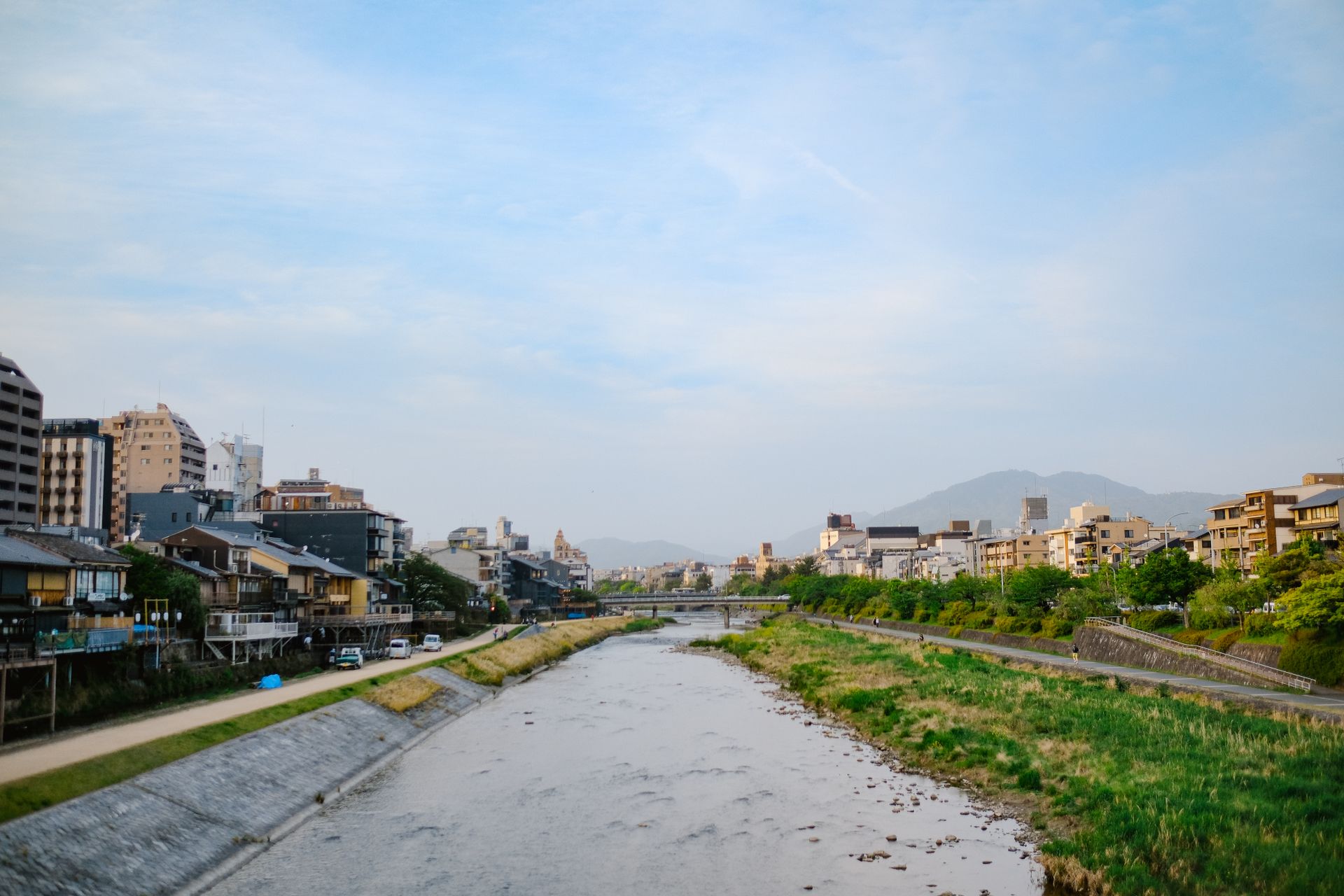 A picturesque view of the Kamo River with traditional architecture in Kyoto, Japan.