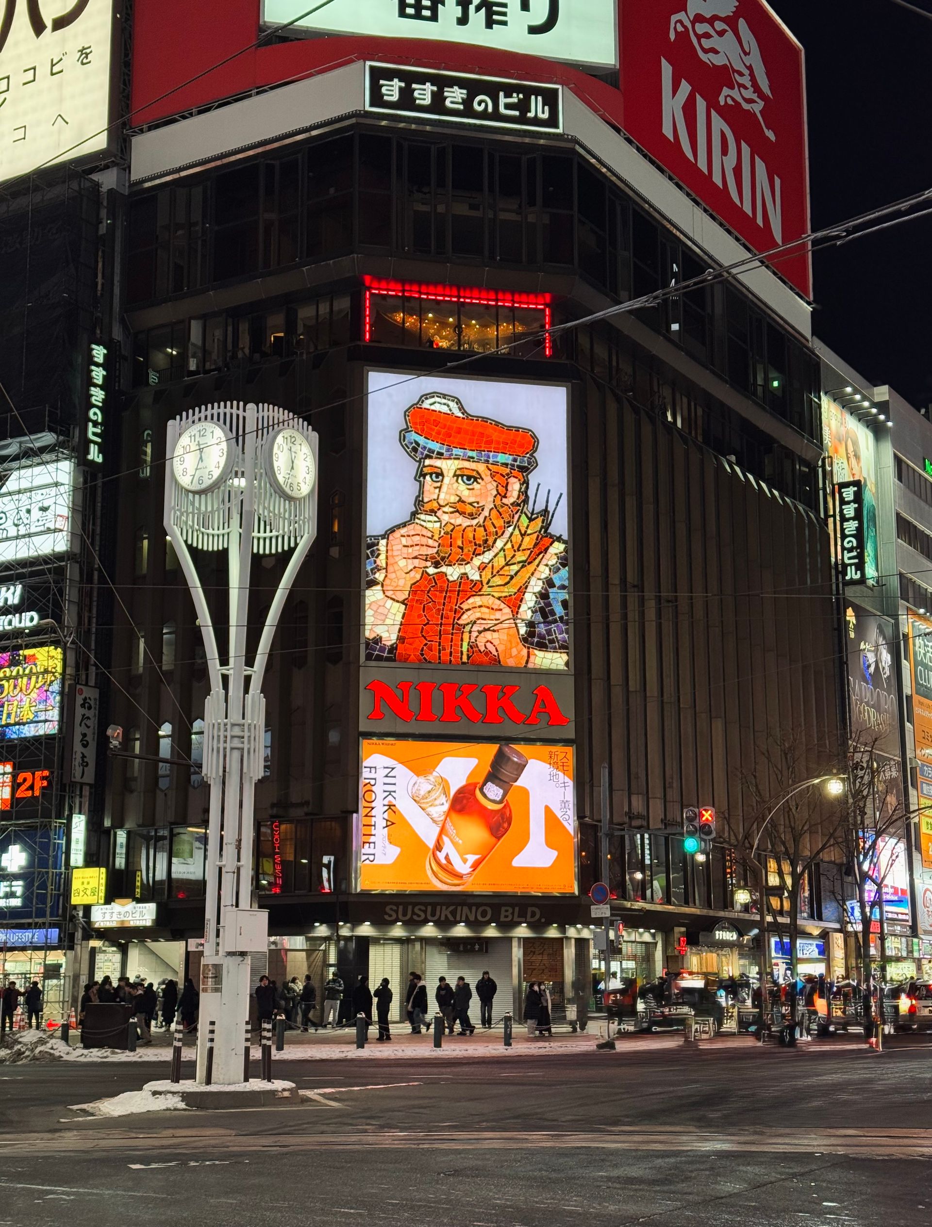 Night view of the vibrant Susukino District in Sapporo, showcasing the famous Nikka sign.