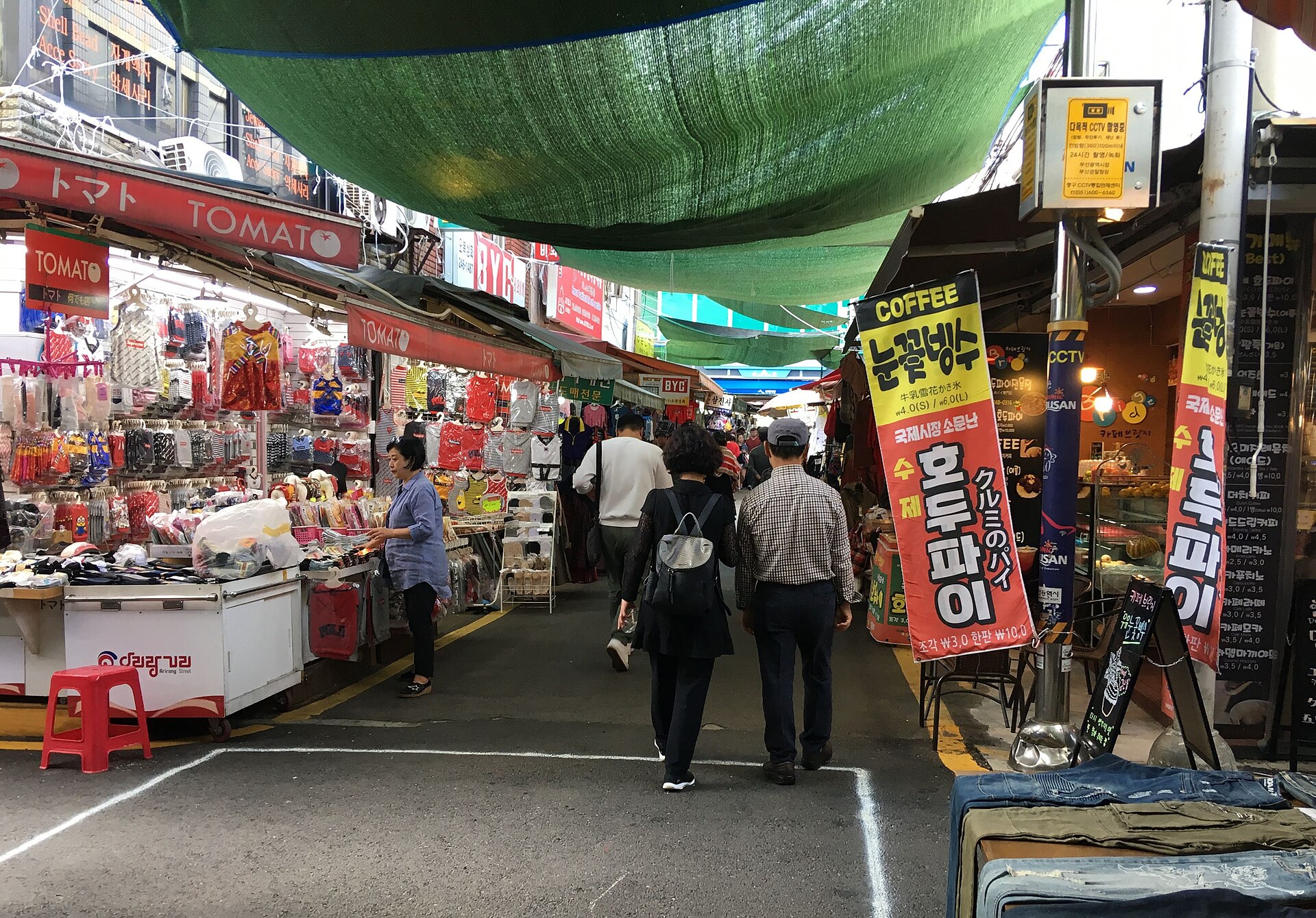 Vibrant street food stall at Busan International Film Festival serving skewers.