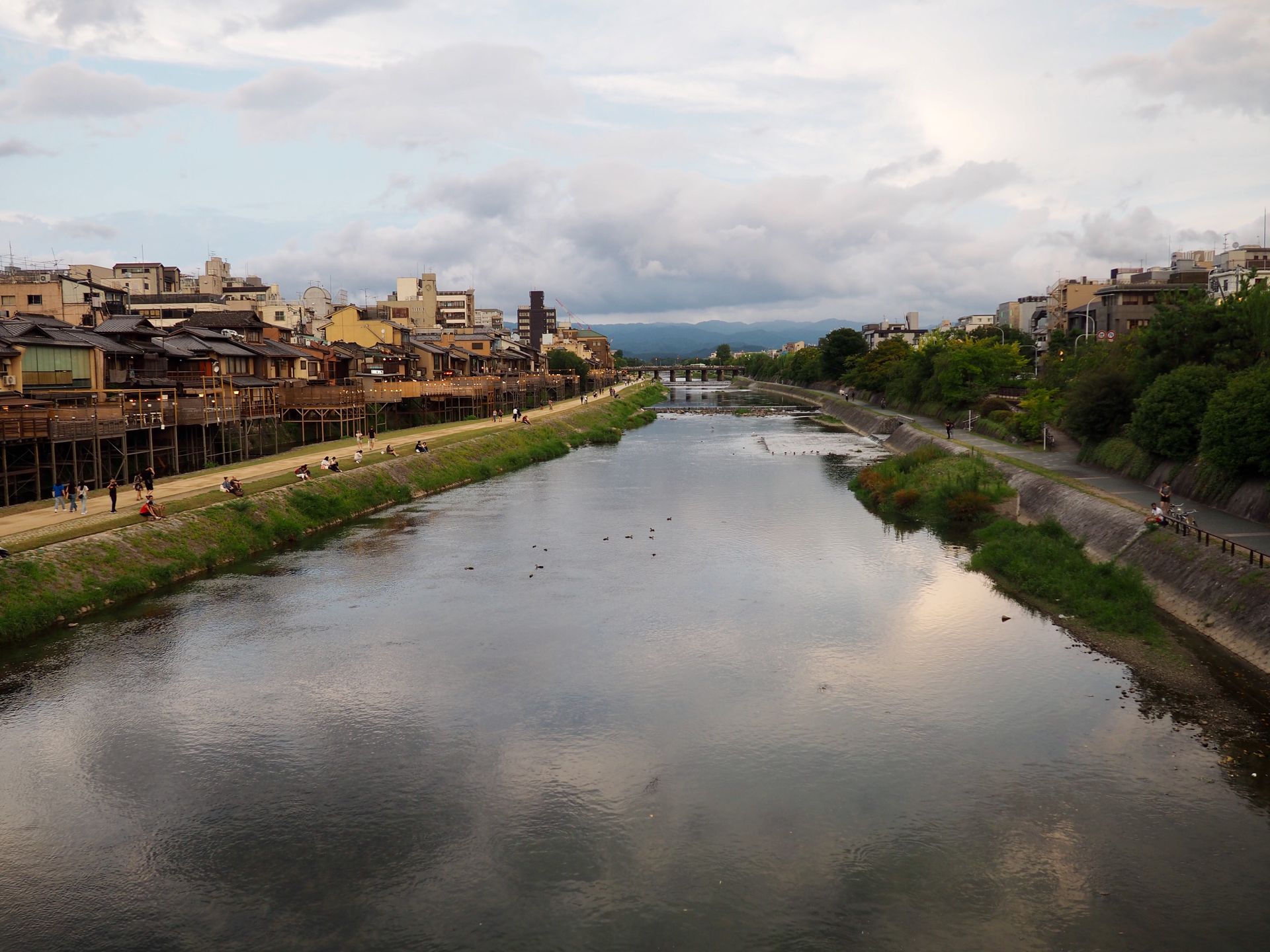Beautiful view of a calm river with historic buildings along the banks in Kyoto, Japan.