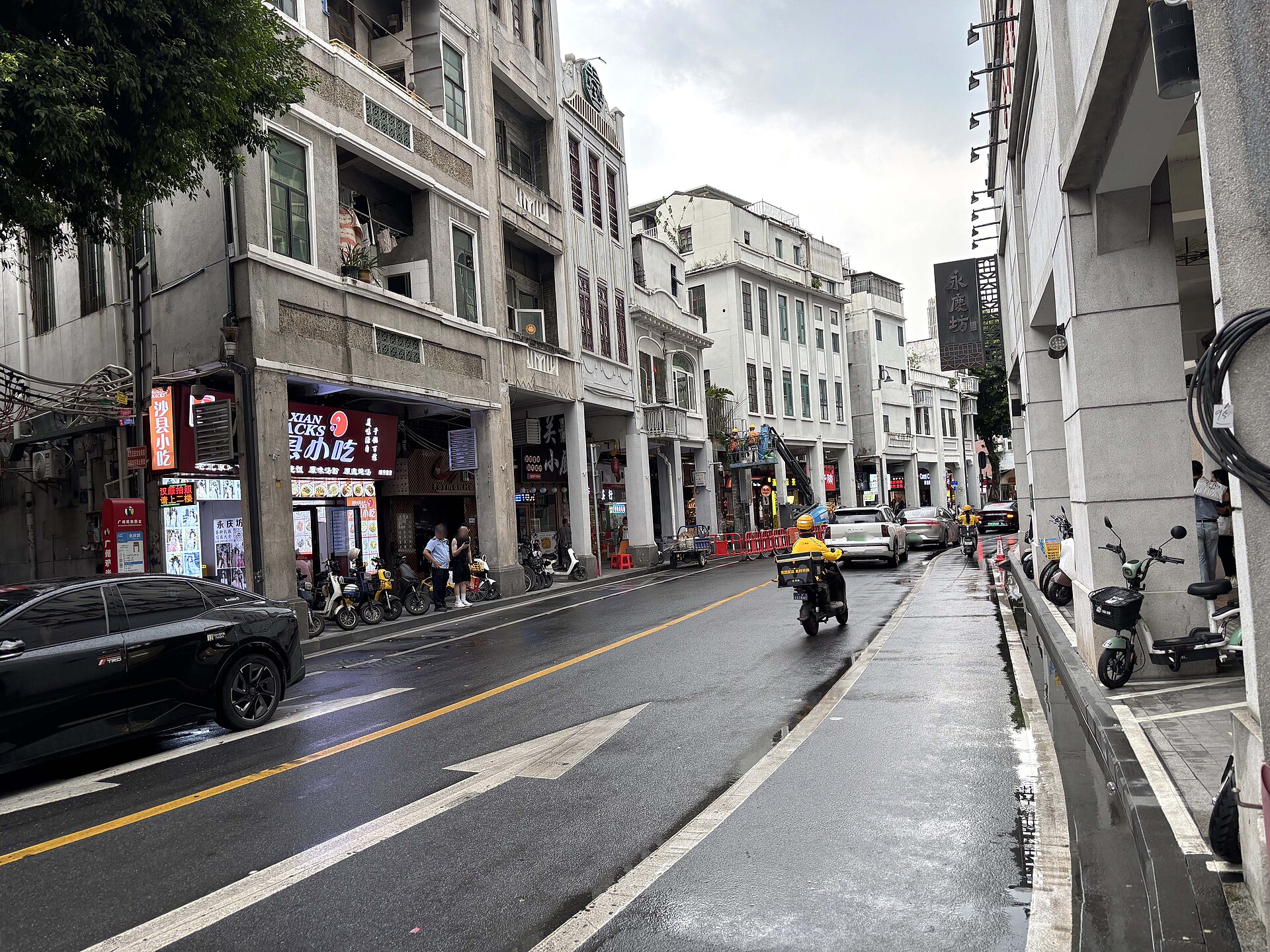 City view of Guangzhou showing high-rise buildings and busy traffic on an overcast day.