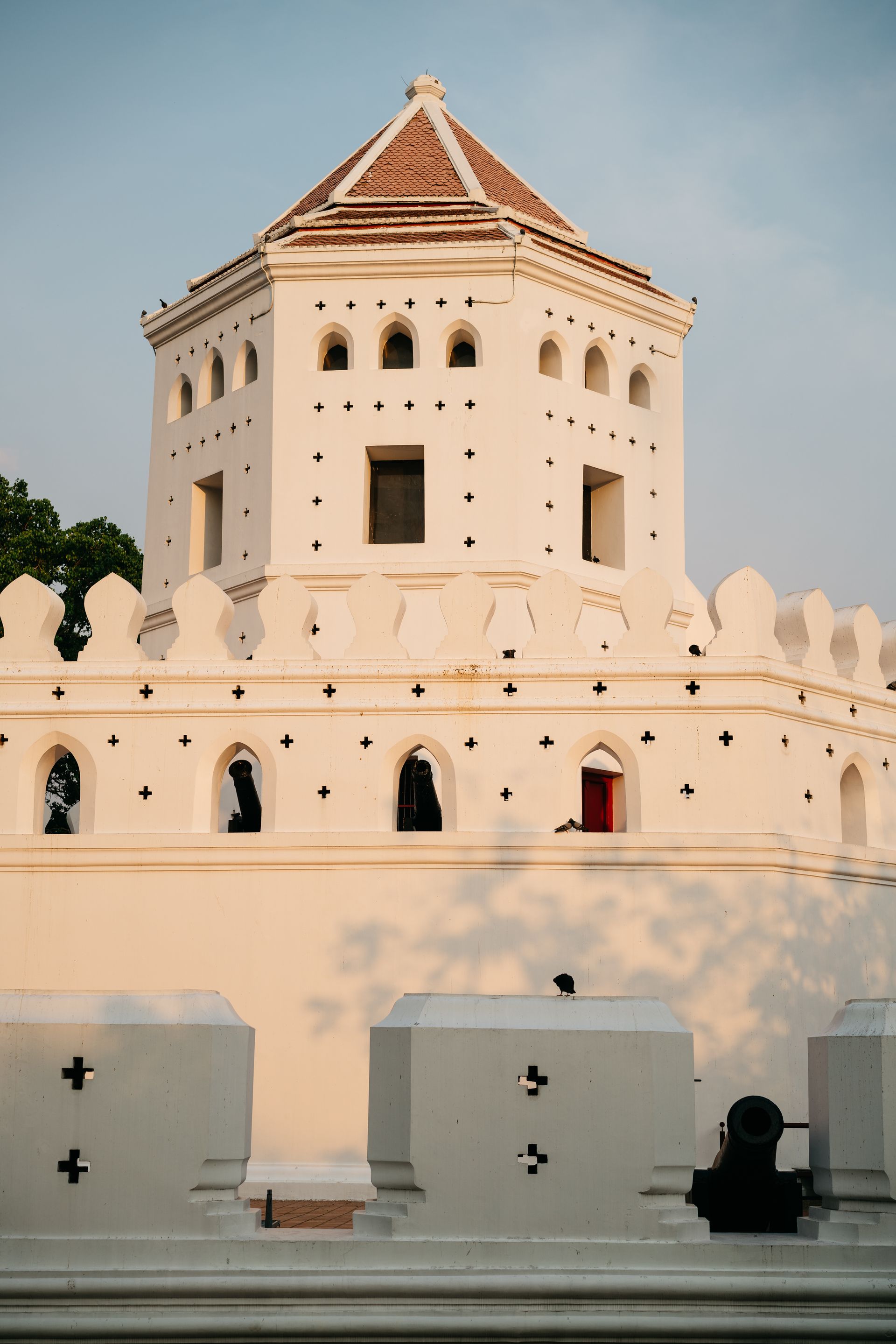 A historic fort showcasing unique white architecture and ornamental battlements in sunset light.
